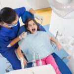 A dentist treating a children