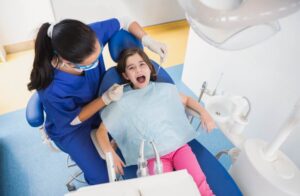 A dentist treating a children
