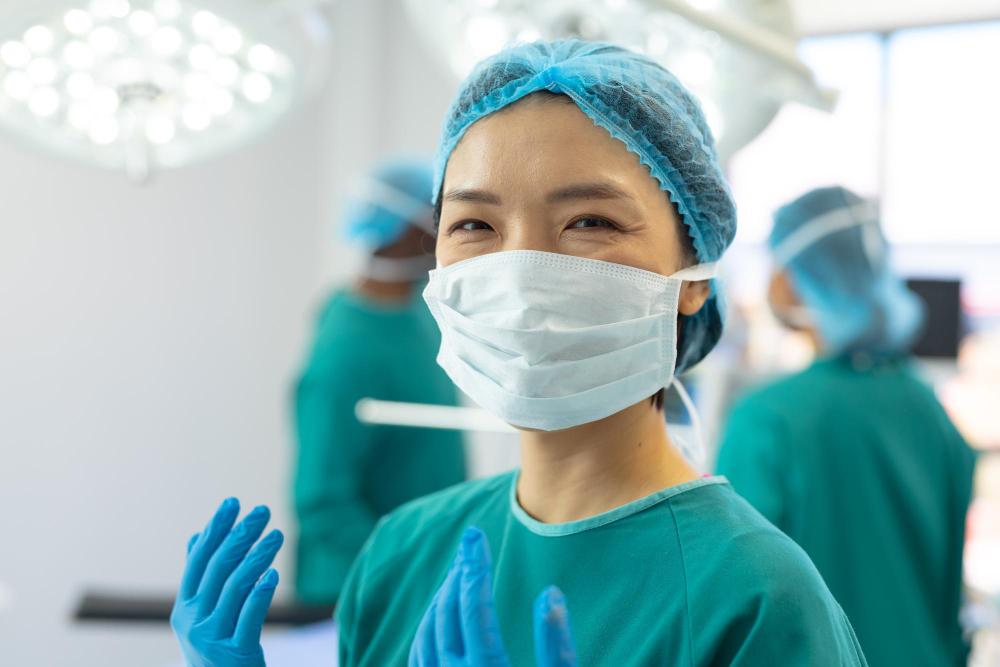 A surgeon in a surgical mask and gloves in an operation room. (illustration)